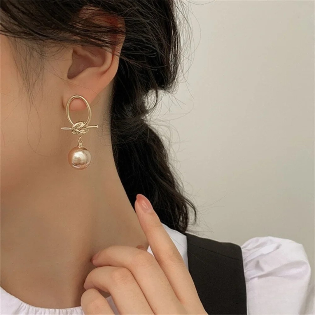 Boucles d'oreilles dorées avec perle